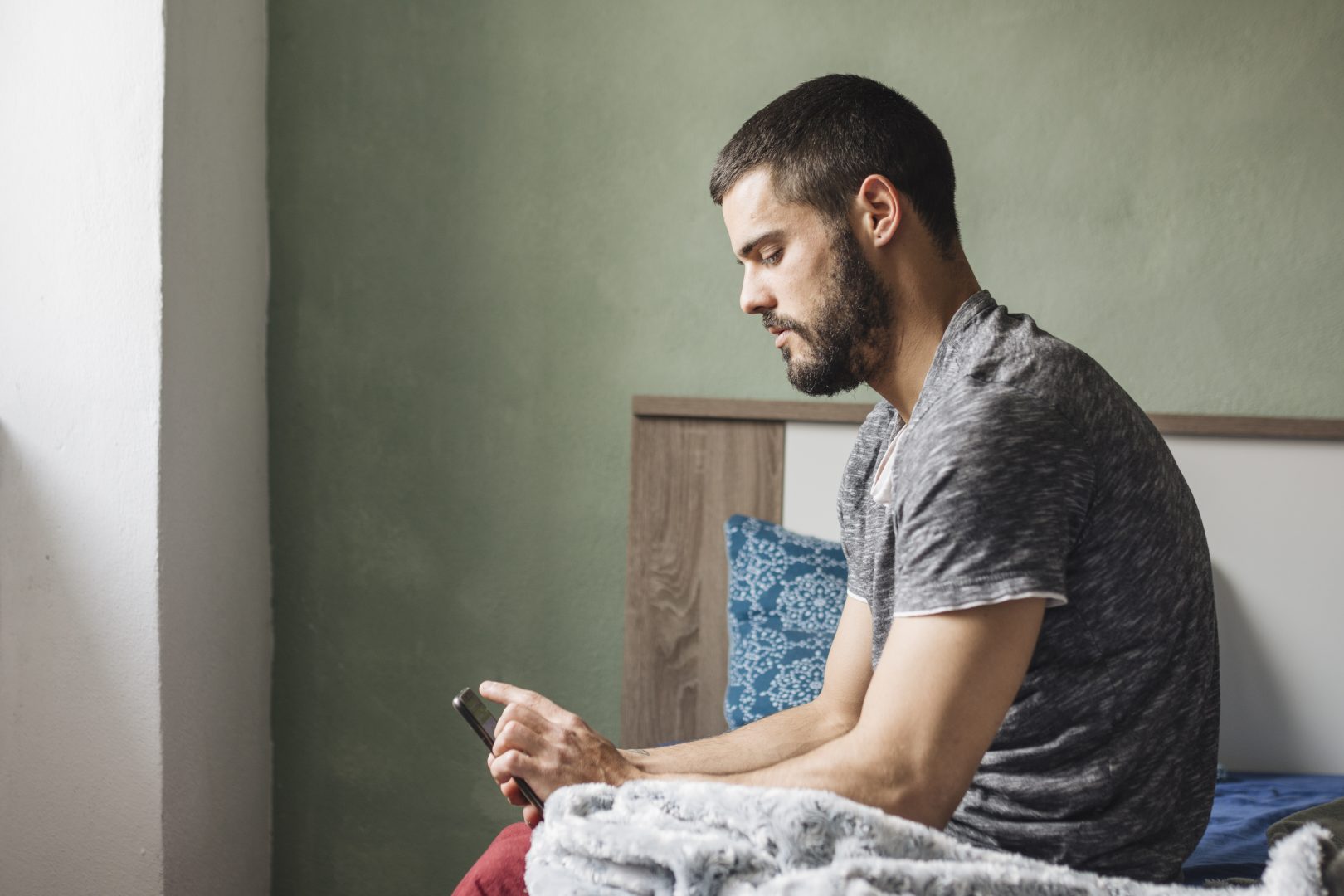 man using smartphone home